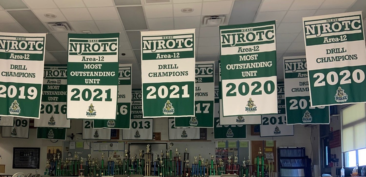 The newly raised 2021 Area-12 Most Outstanding Unit and Drill Champion banners hang from the rafters at Nease.